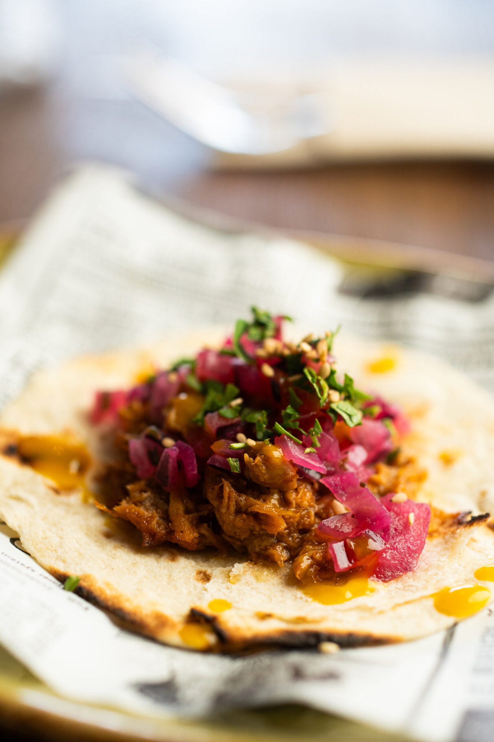 Mexican taco with shredded meat and pickled onions