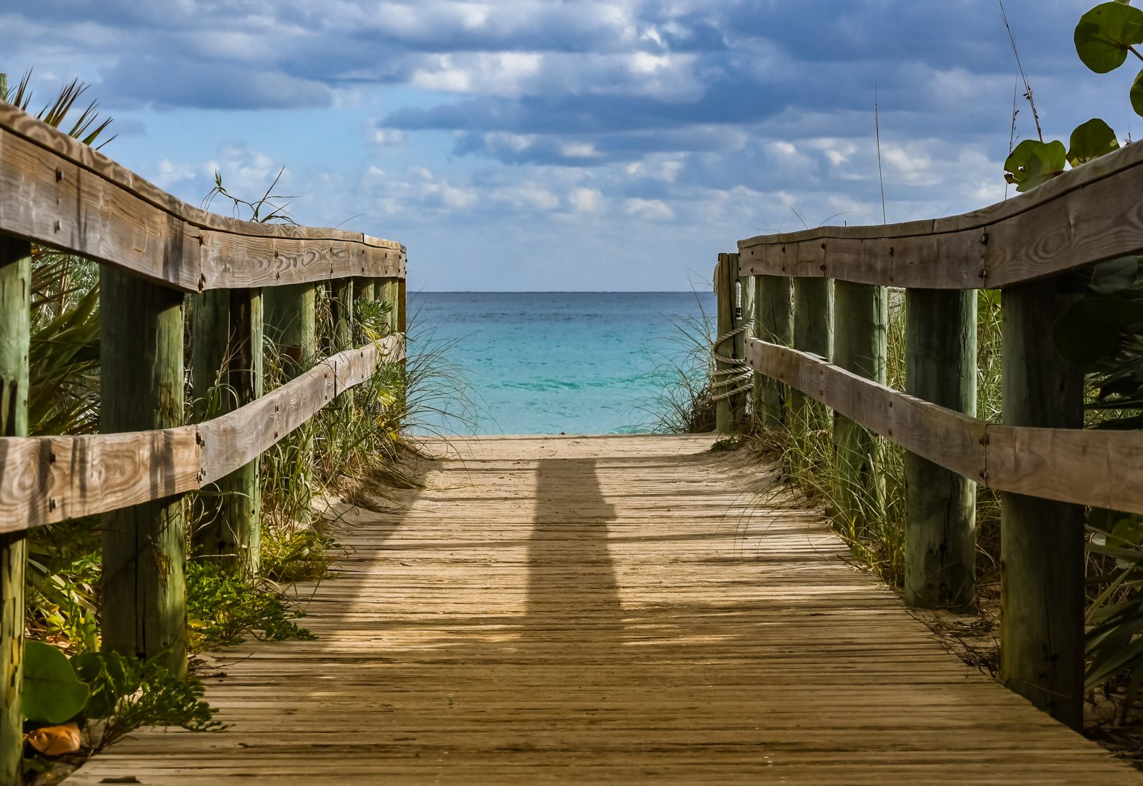 Wooden walkway leading toward the turquoise waters of Bacalar