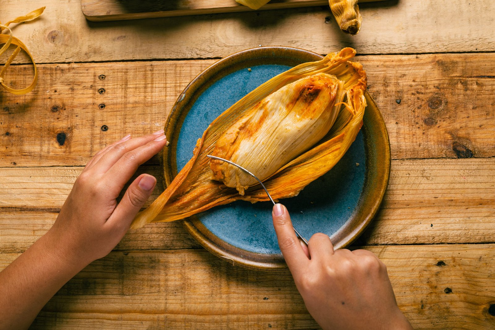 Traditional tamale served on a blue plate in Costa Maya, Mexico